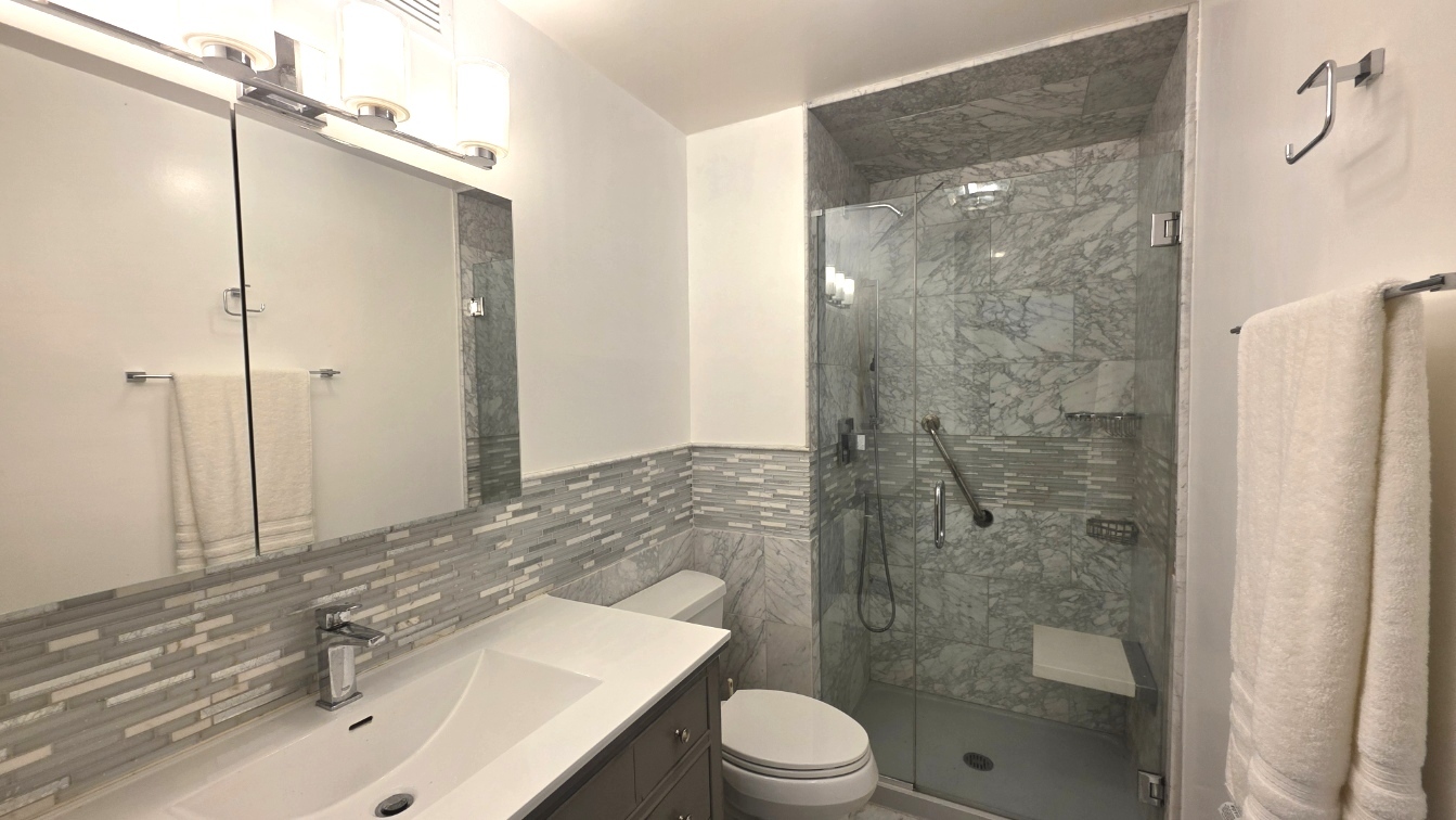6033 North Sheridan Road, Unit 5G Chicago, IL 60660 - Photo 14 of 24 a bathroom with a sink a toilet and shower