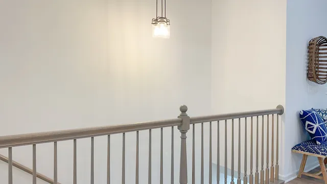 a view of a hallway with wooden floor and a window