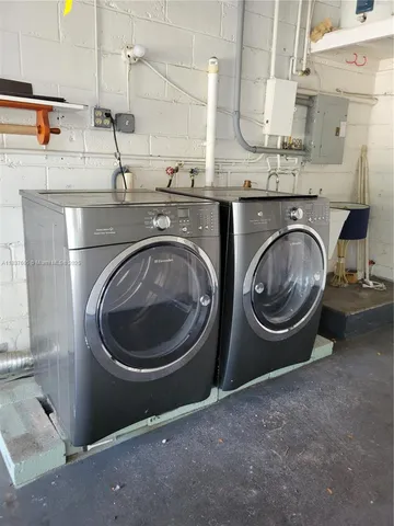 a utility room with sink dryer and washer