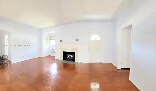 a view of empty room with a fireplace