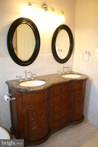 6021 Craft Road Alexandria, VA 22310 - Photo 17 of 30 a bathroom with a granite countertop sink and a mirror