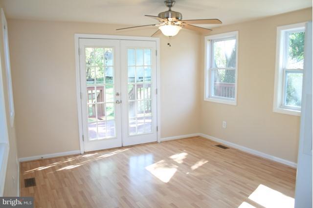 6021 Craft Road Alexandria, VA 22310 - Photo 18 of 30 an empty room with wooden floor fan and windows