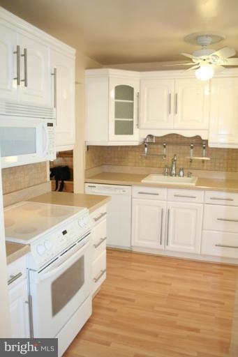6021 Craft Road Alexandria, VA 22310 - Photo 27 of 30 a large white kitchen with stove top oven and cabinets