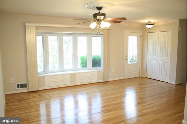 6021 Craft Road Alexandria, VA 22310 - Photo 7 of 30 a view of an empty room with wooden floor and a window