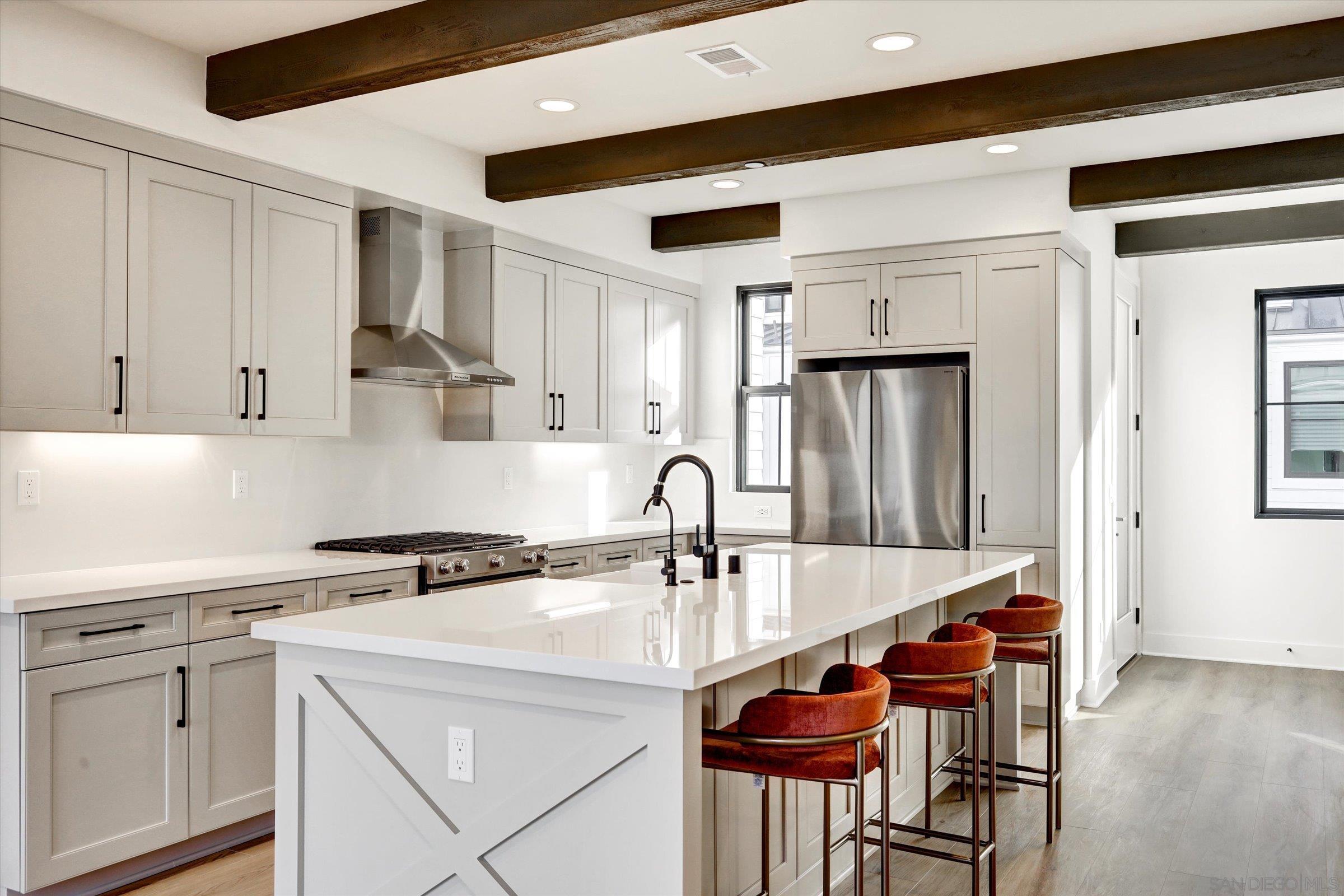 a kitchen with stainless steel appliances a sink and a refrigerator