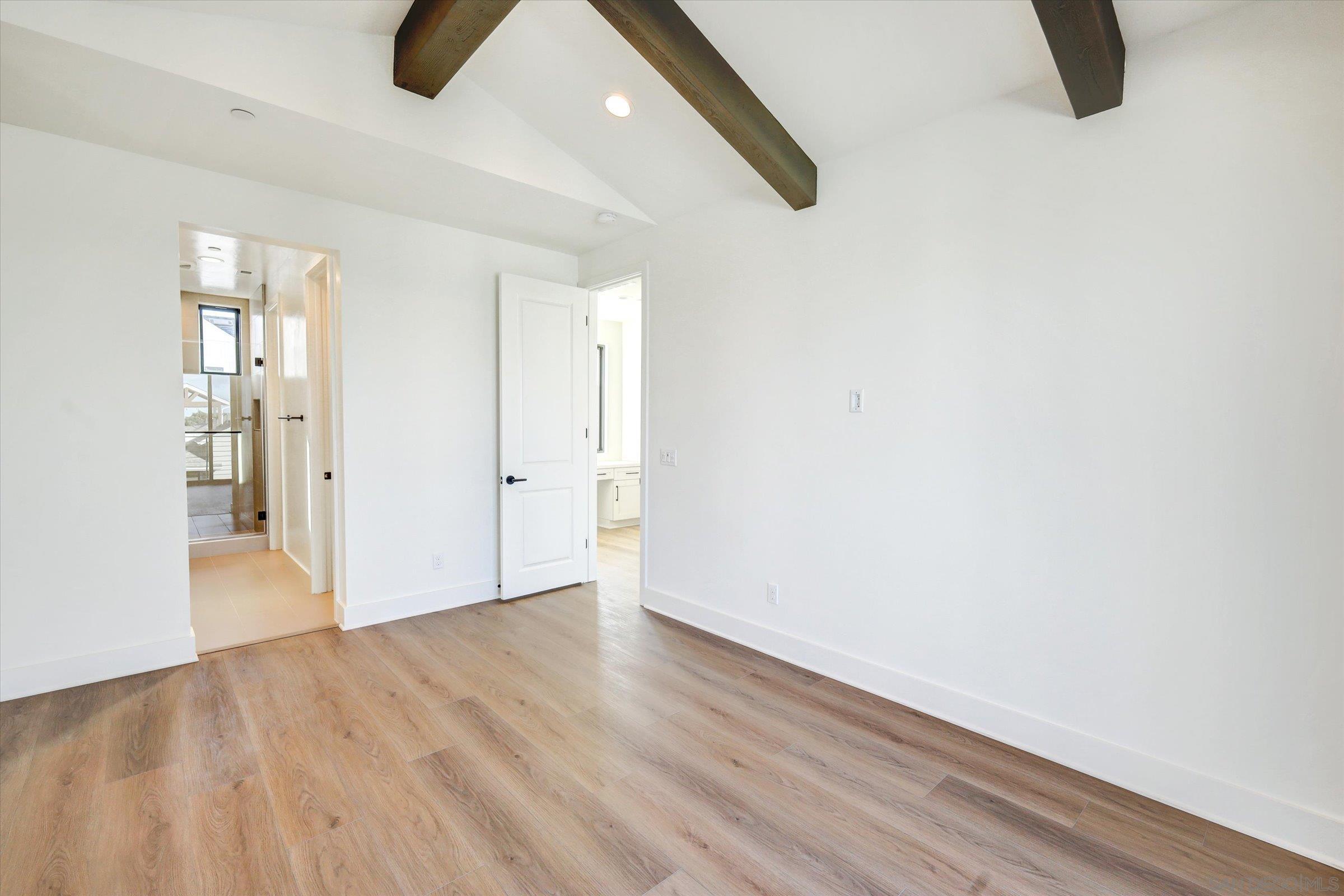1602 Pl Encinitas Ca, Unit 104 Encinitas, CA 92024 - Photo 7 of 22 a view of an empty room with wooden floor