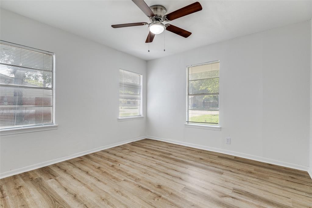 217 Ridgeway Avenue Azle, TX 76020 - Photo 13 of 27 a view of empty room with wooden floor and fan