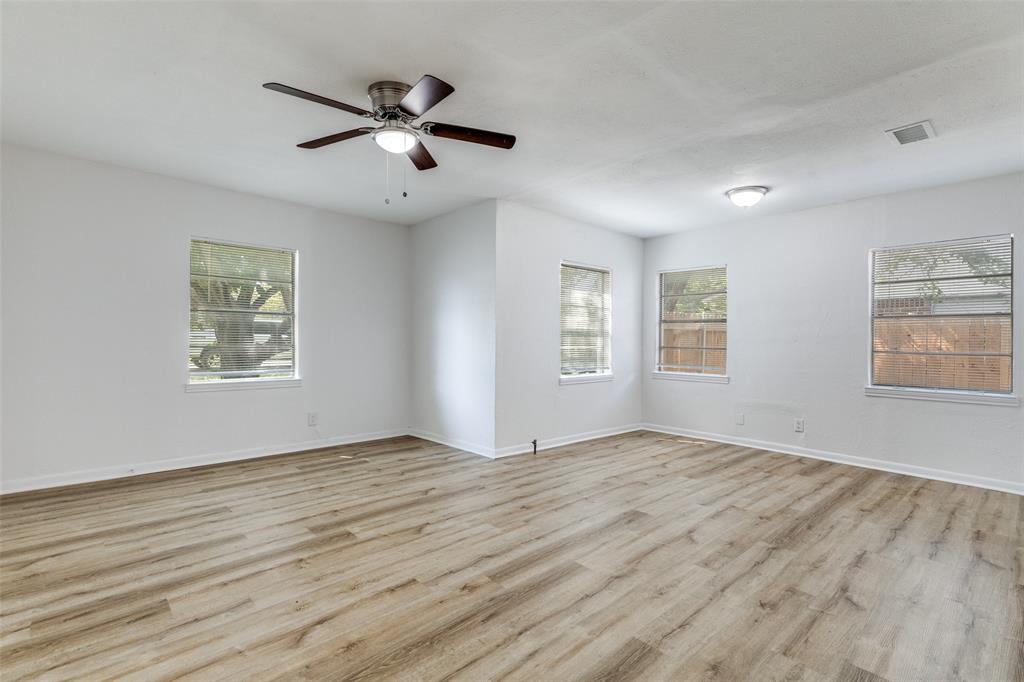 217 Ridgeway Avenue Azle, TX 76020 - Photo 19 of 27 wooden floor in an empty room with a window