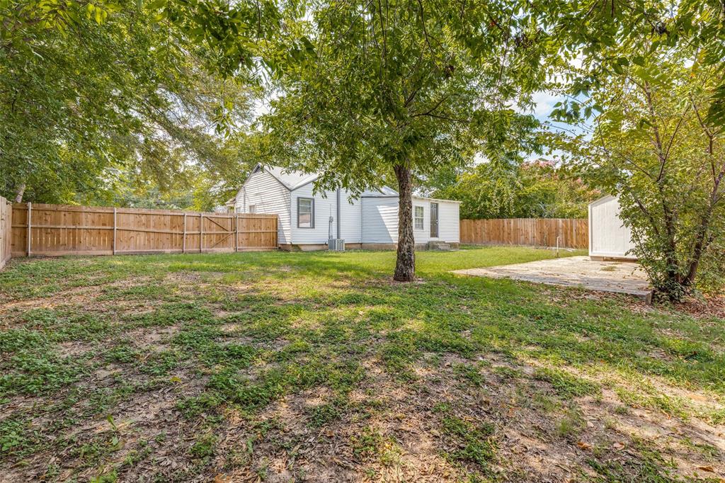 217 Ridgeway Avenue Azle, TX 76020 - Photo 22 of 27 a view of a yard with a house and large tree