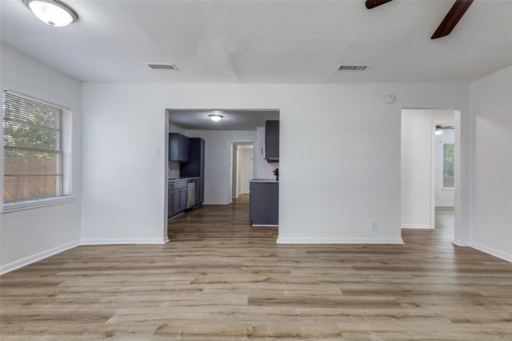 217 Ridgeway Avenue Azle, TX 76020 - Photo 9 of 27 a view of a big room with wooden floor and windows