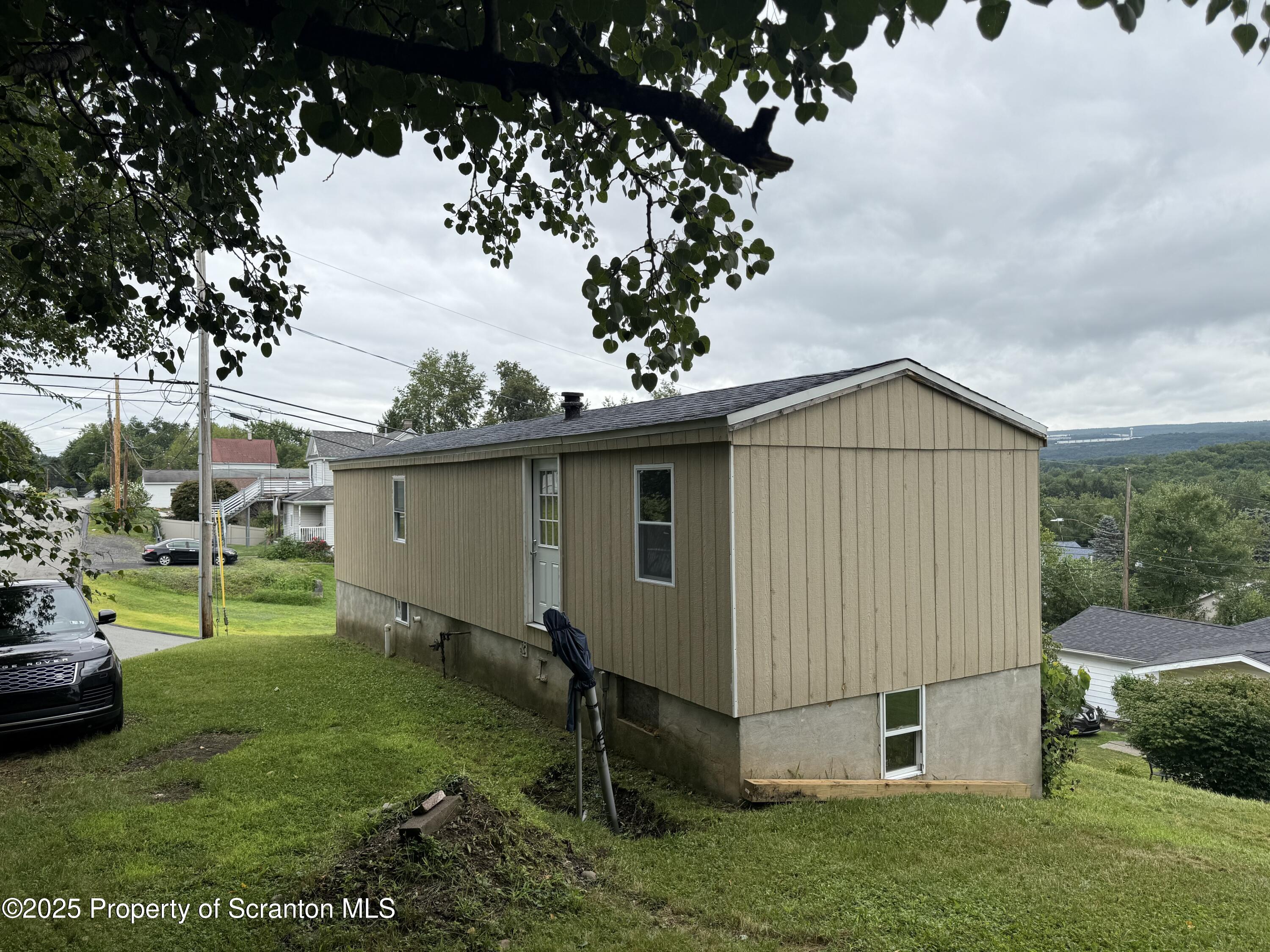 1002 Ridge Street, Unit L 38 Olyphant, PA 18447 - Photo 4 of 15 a view of backyard with barbeque grill and a fountain