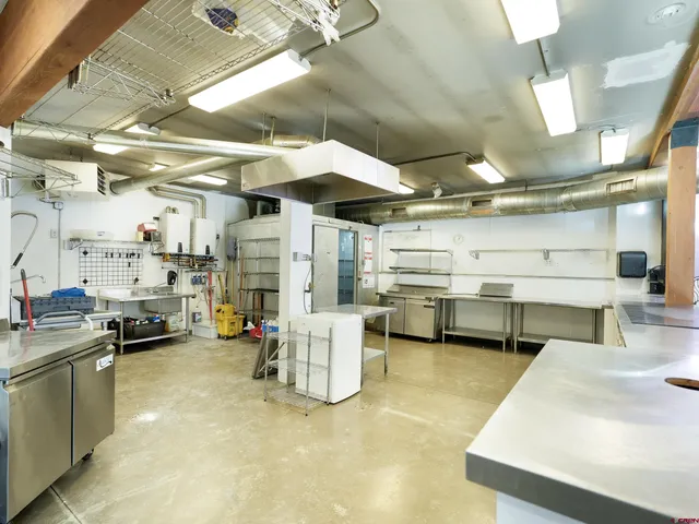 a kitchen with stainless steel appliances granite countertop a sink and white cabinets