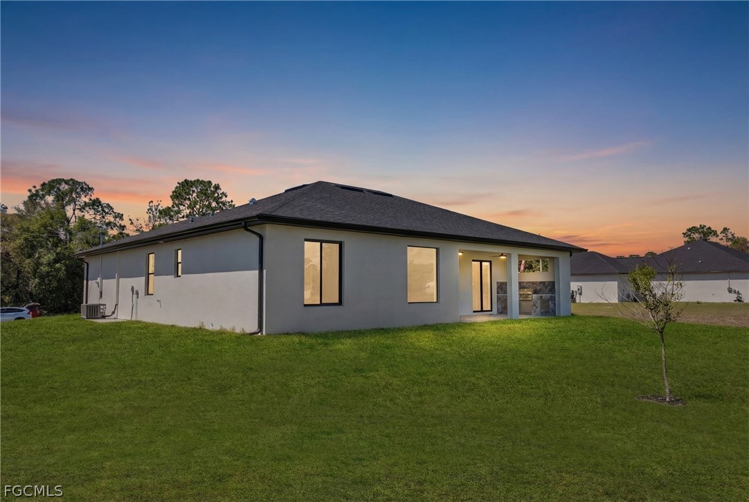 6029 Keystone Circle LaBelle, FL 33935 - Photo 47 of 50 a house that is sitting in the grass with large trees