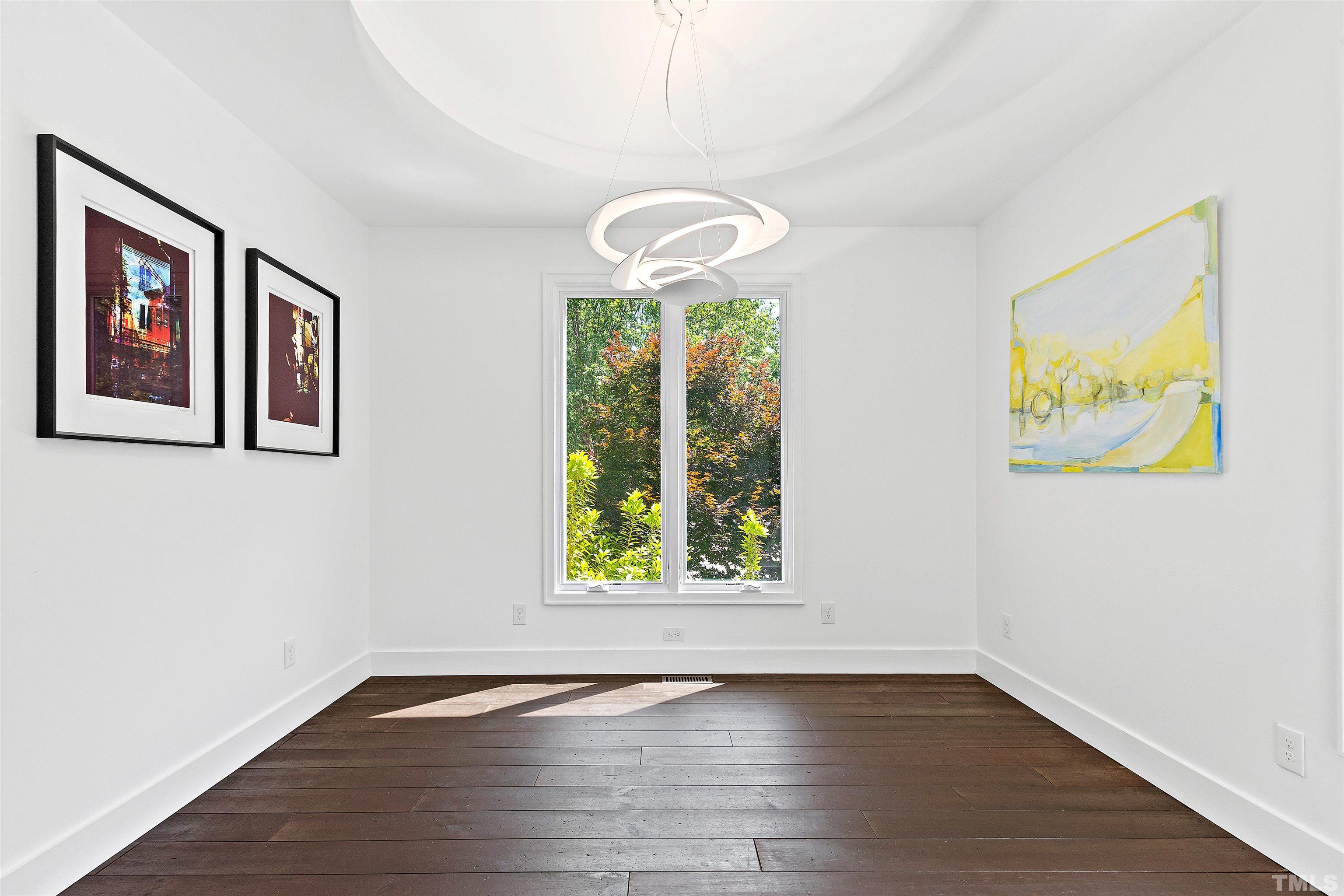 2105 Pine Drive Raleigh, NC 27608 - Photo 19 of 54 a view of an empty room with wooden floor and a window