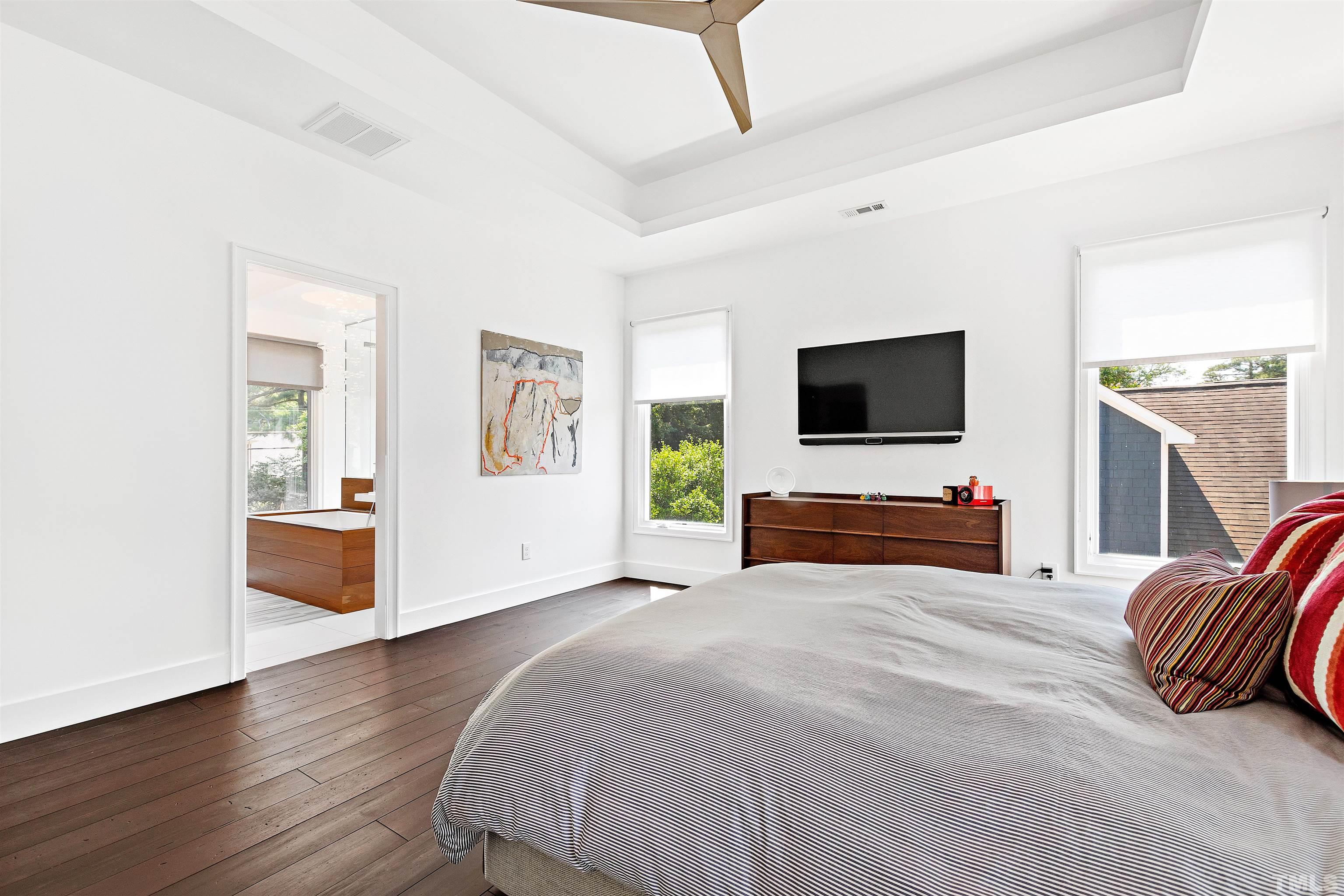2105 Pine Drive Raleigh, NC 27608 - Photo 22 of 54 a bedroom with a bed and a flat screen tv