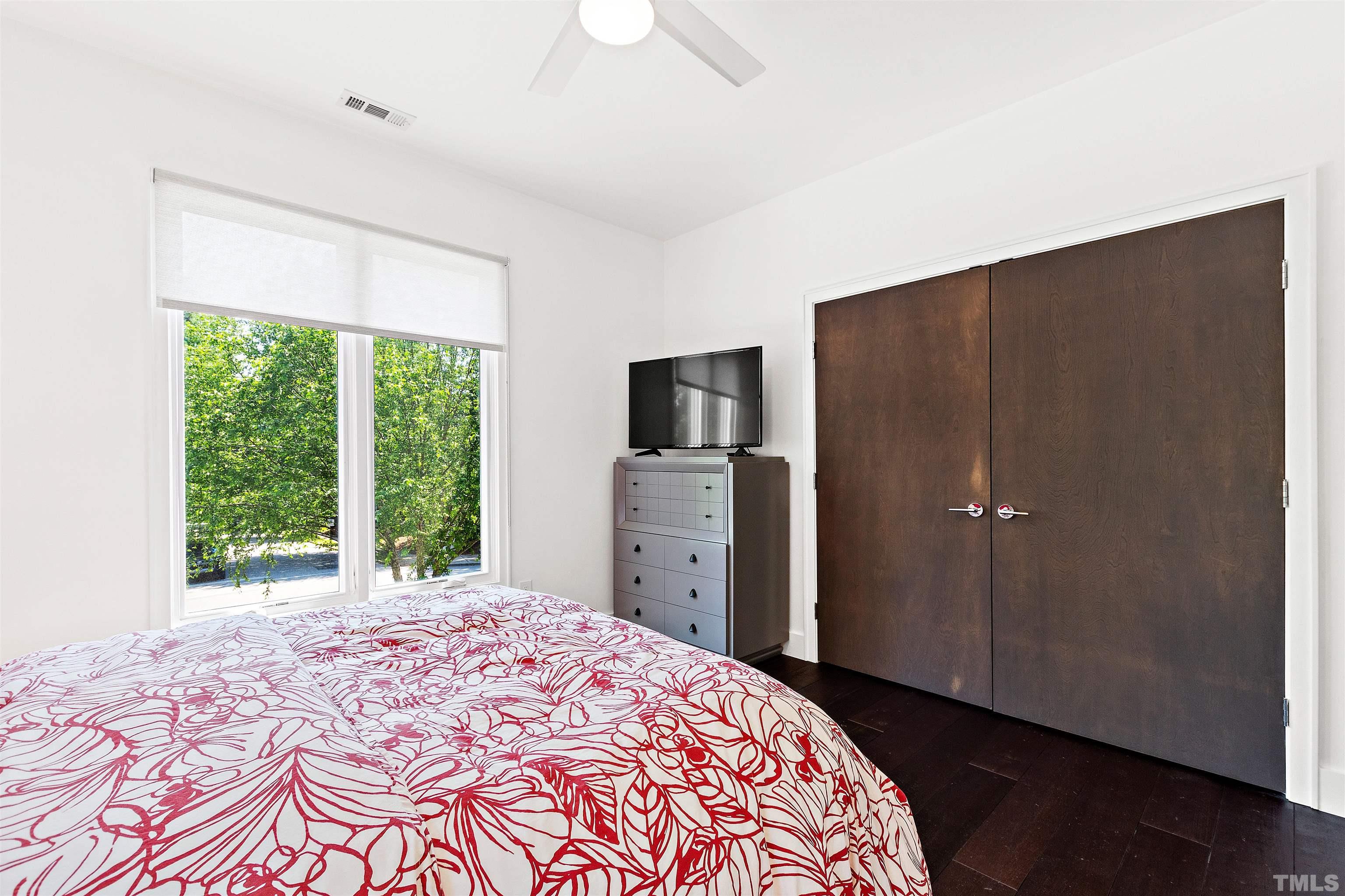 2105 Pine Drive Raleigh, NC 27608 - Photo 26 of 54 a bedroom with a bed and a flat screen tv