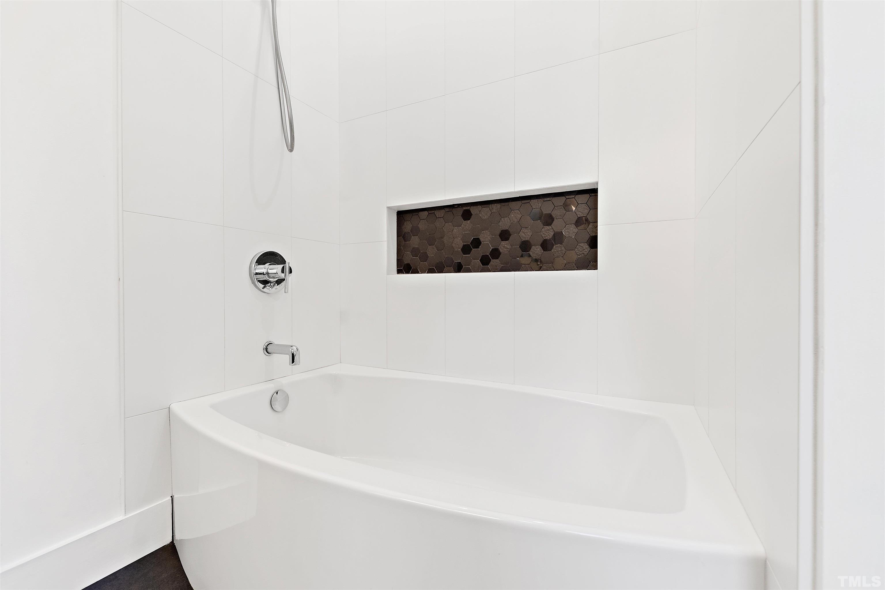 2105 Pine Drive Raleigh, NC 27608 - Photo 28 of 54 a white bath tub sitting in a bathroom