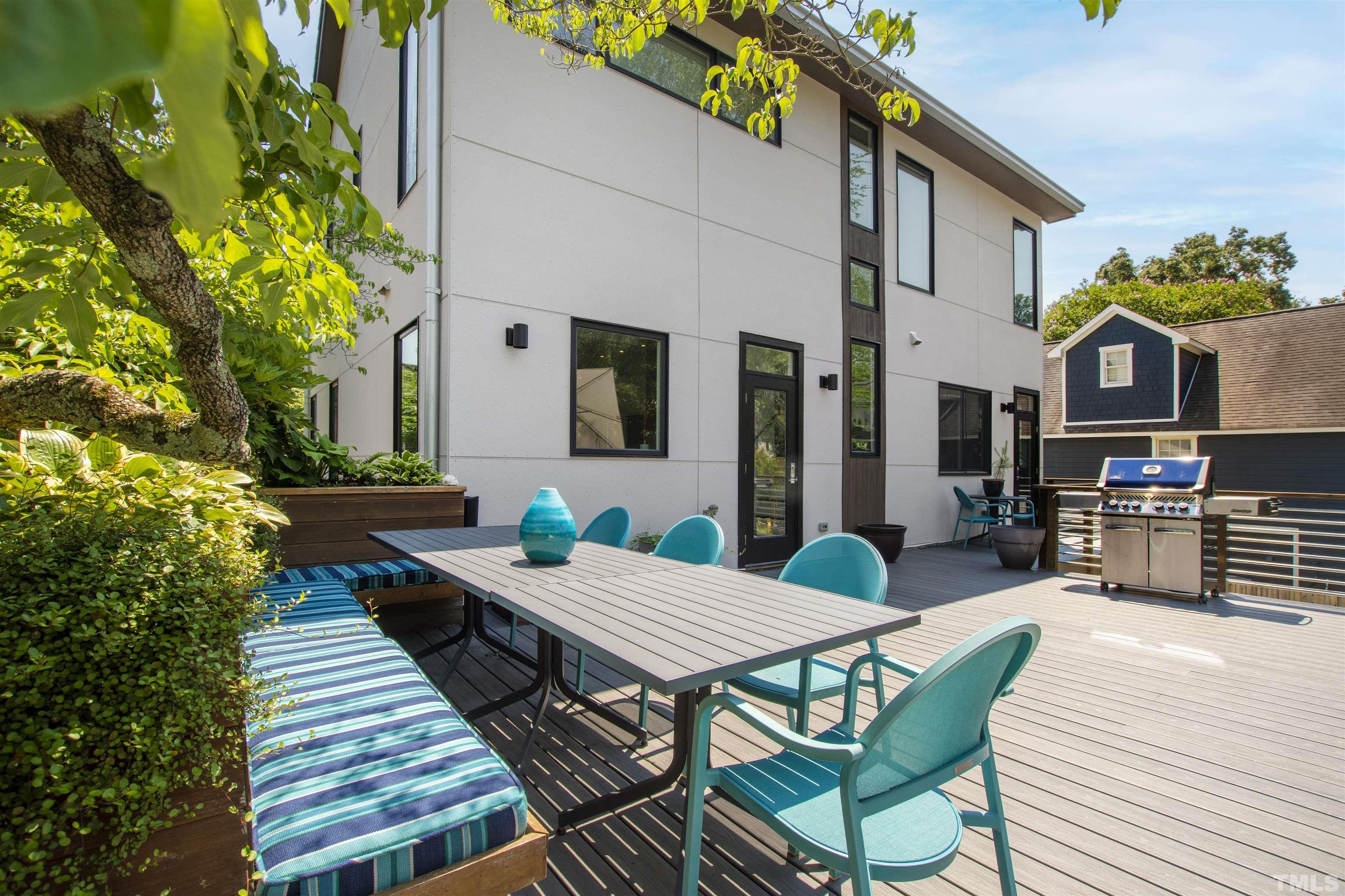 2105 Pine Drive Raleigh, NC 27608 - Photo 41 of 54 a view of a patio with table and chairs and potted plants with wooden floor