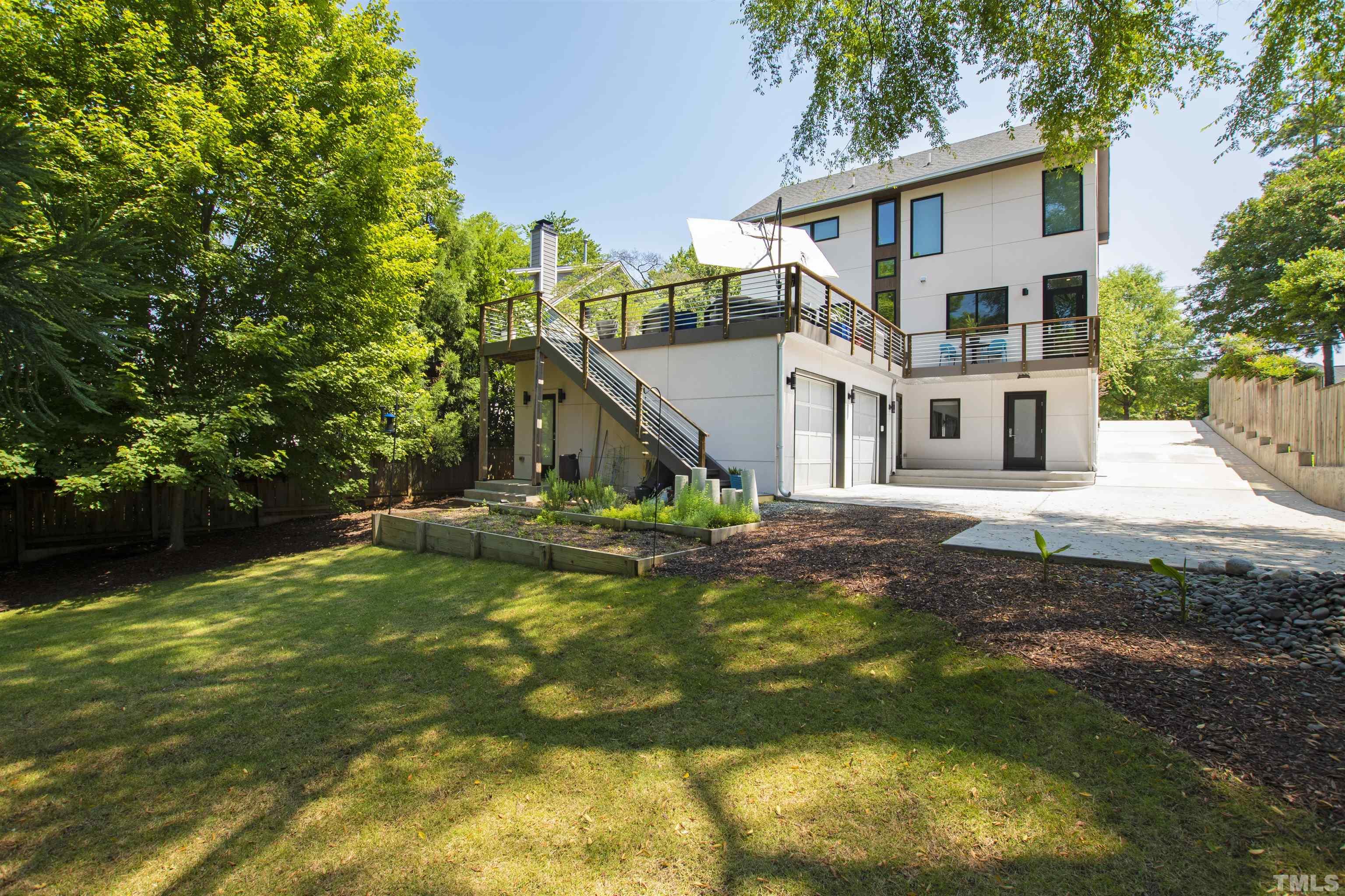 2105 Pine Drive Raleigh, NC 27608 - Photo 45 of 54 a view of a house with a yard patio and fire pit