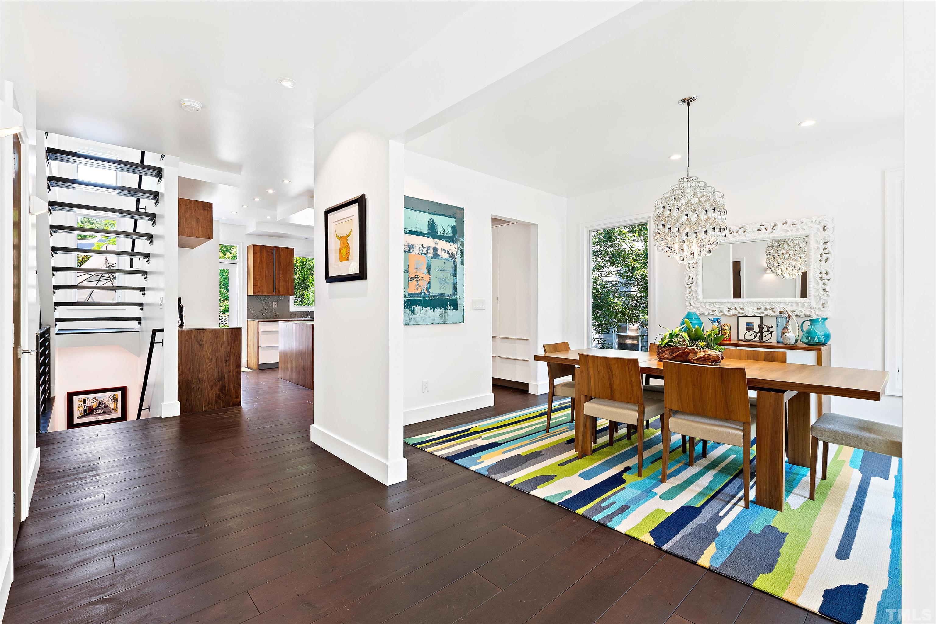 2105 Pine Drive Raleigh, NC 27608 - Photo 5 of 54 a living room with furniture and a dining table with wooden floor