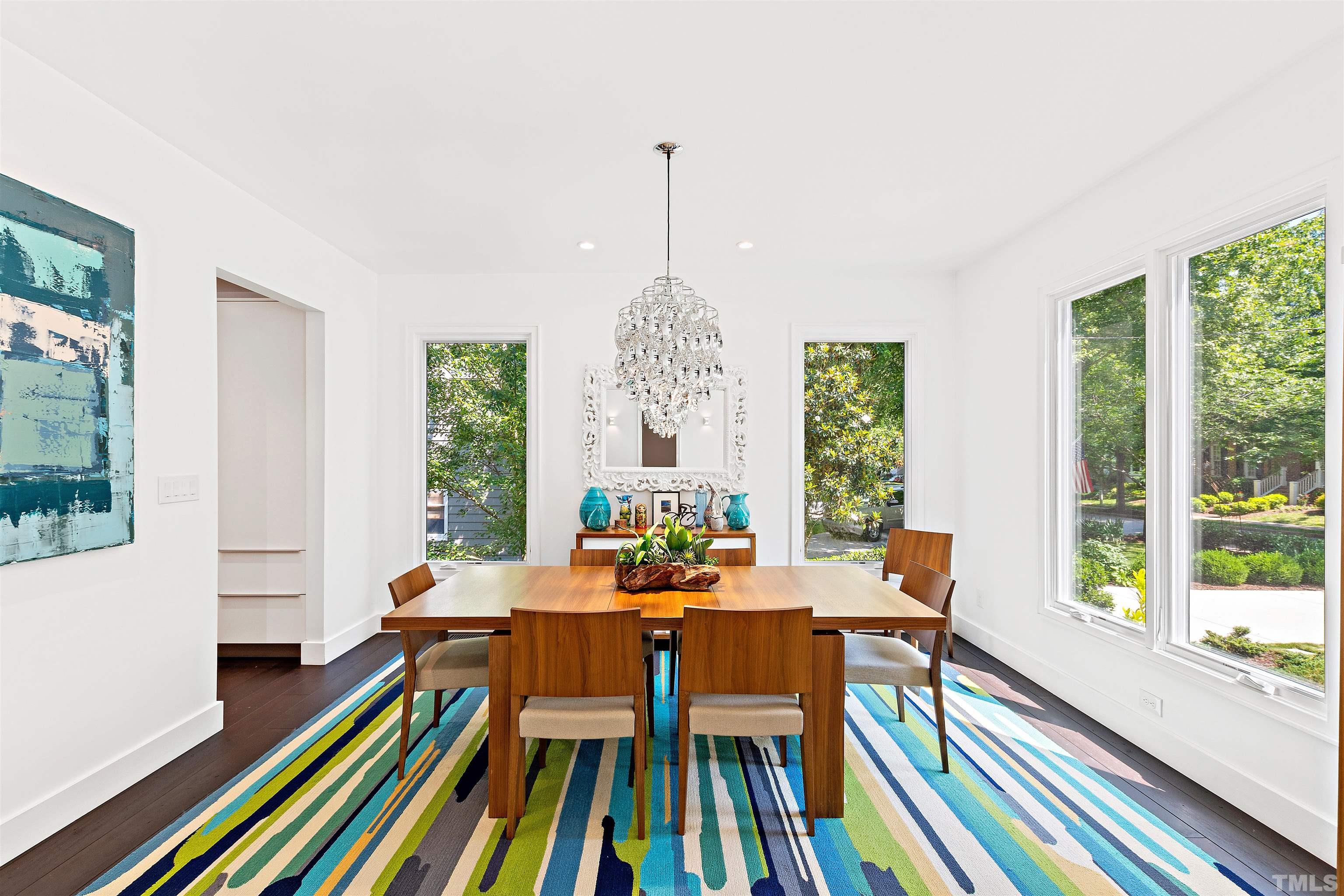 2105 Pine Drive Raleigh, NC 27608 - Photo 7 of 54 a dining room with furniture a chandelier and wooden floor