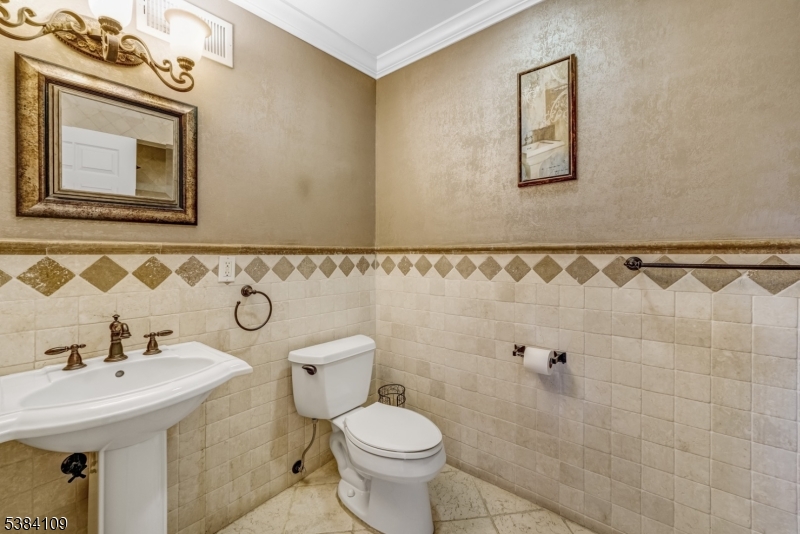 207 Eileen Drive Cedar Grove, NJ 07009 - Photo 12 of 26 a bathroom with a sink mirror and toilet