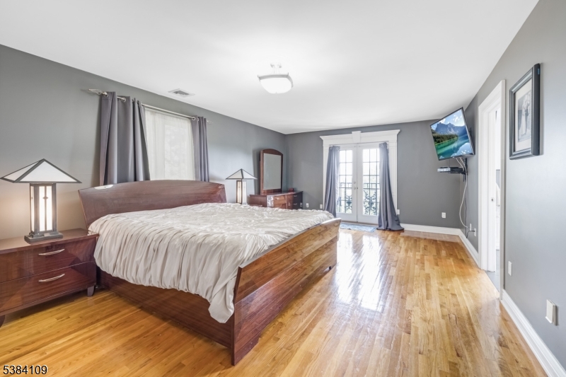 207 Eileen Drive Cedar Grove, NJ 07009 - Photo 13 of 26 a spacious bedroom with a bed and a window
