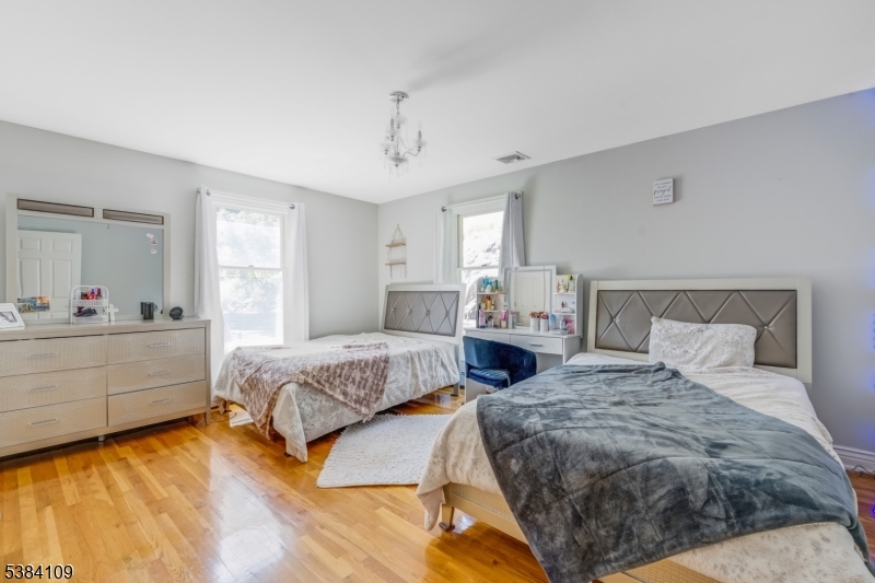 207 Eileen Drive Cedar Grove, NJ 07009 - Photo 17 of 26 a spacious bedroom with a bed and window