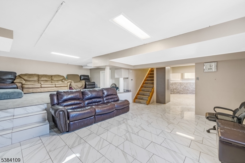 207 Eileen Drive Cedar Grove, NJ 07009 - Photo 21 of 26 a living room with furniture and a flat screen tv