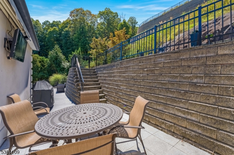 207 Eileen Drive Cedar Grove, NJ 07009 - Photo 22 of 26 a backyard of a house with table and chairs