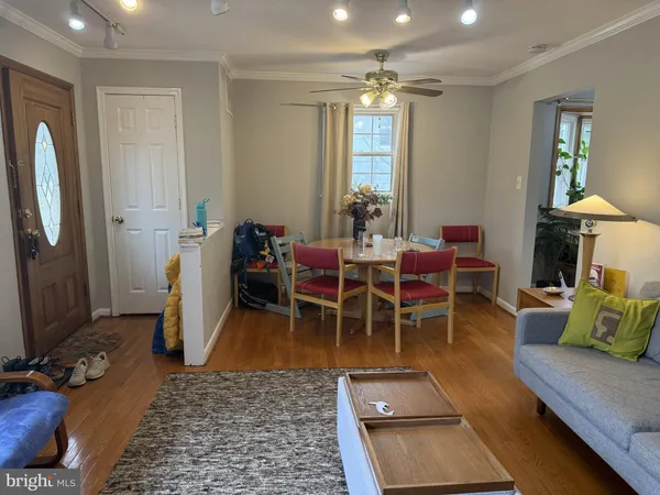 a dining room with furniture and a chandelier