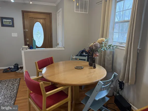 a view of a dining room with furniture and a window