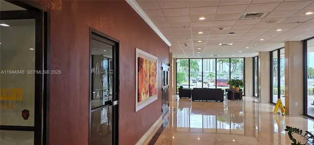 a lobby with furniture and floor to ceiling window