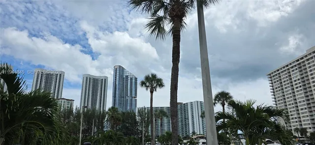 a couple of cars parked in front of a building