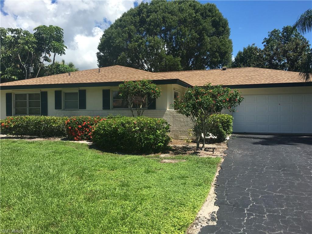a view of a house with a yard potted plants