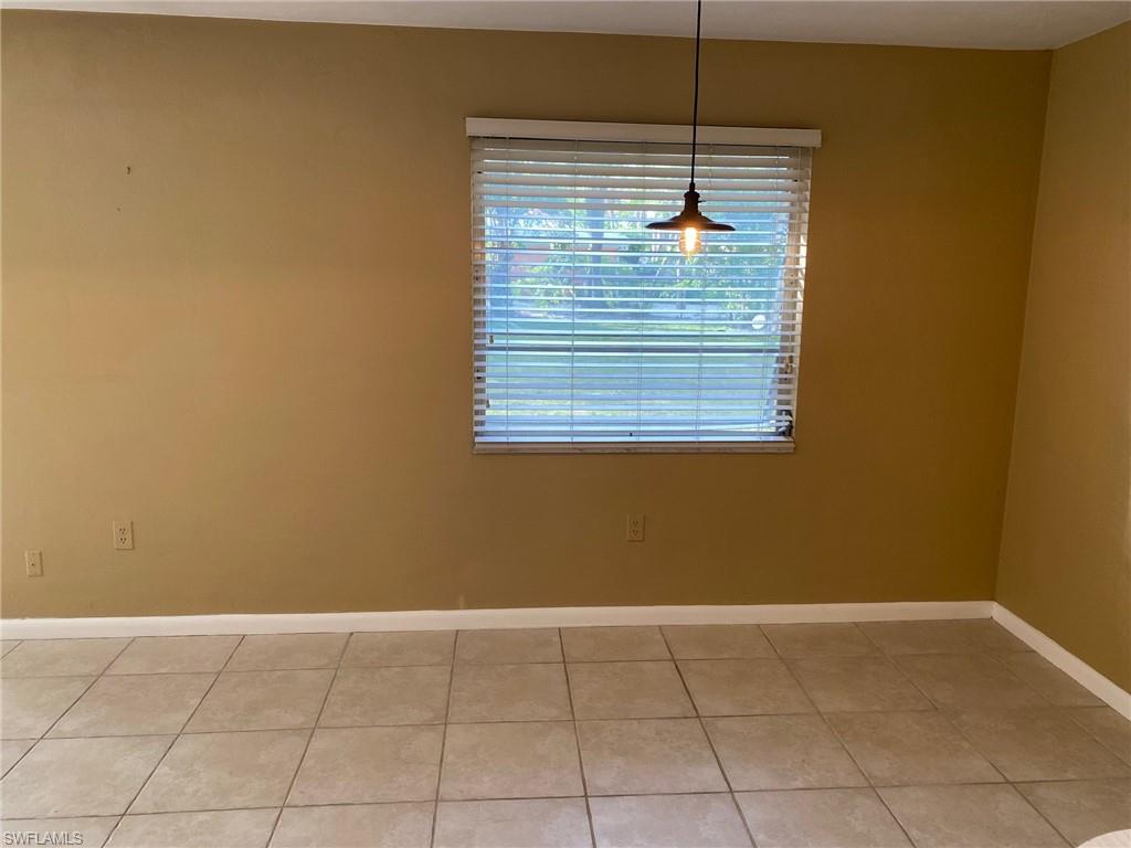 620 Orchid Drive Naples, FL 34102 - Photo 11 of 16 a view of a room with wooden floor and fan