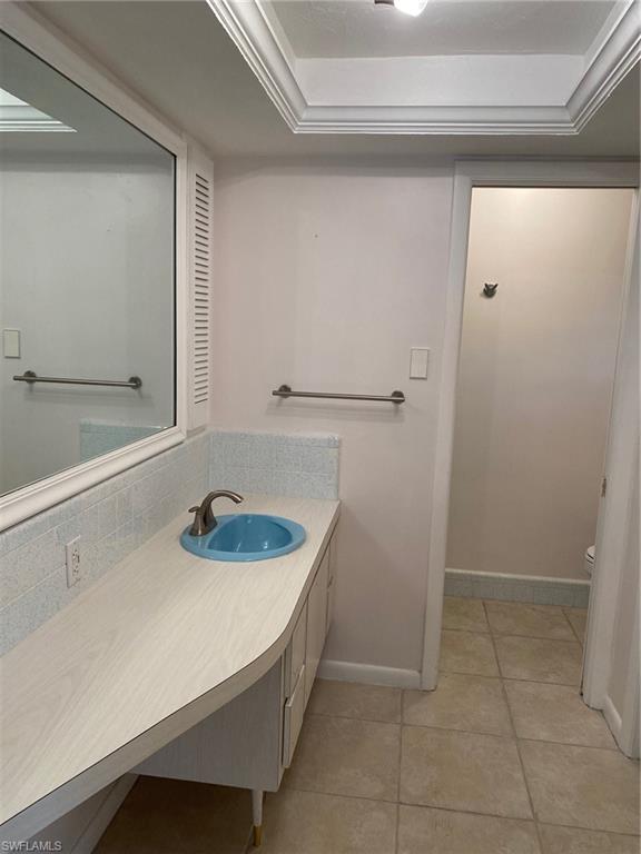 620 Orchid Drive Naples, FL 34102 - Photo 13 of 16 a bathroom with a sink and a mirror