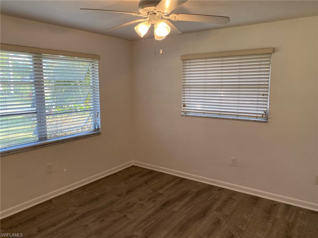 620 Orchid Drive Naples, FL 34102 - Photo 14 of 16 an empty room with wooden floor and windows