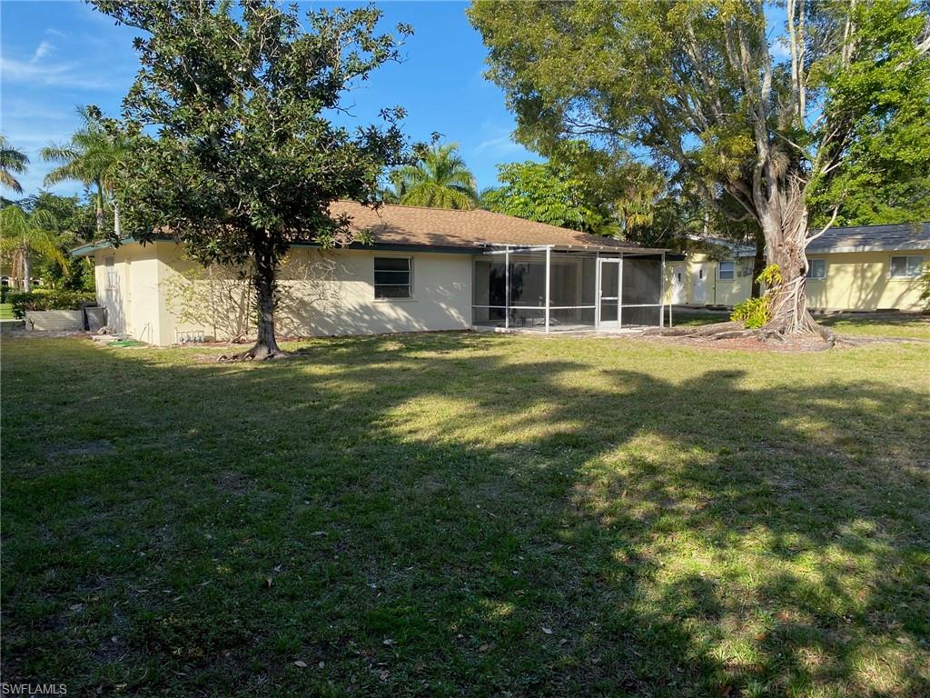 620 Orchid Drive Naples, FL 34102 - Photo 3 of 16 a front view of a house with a garden