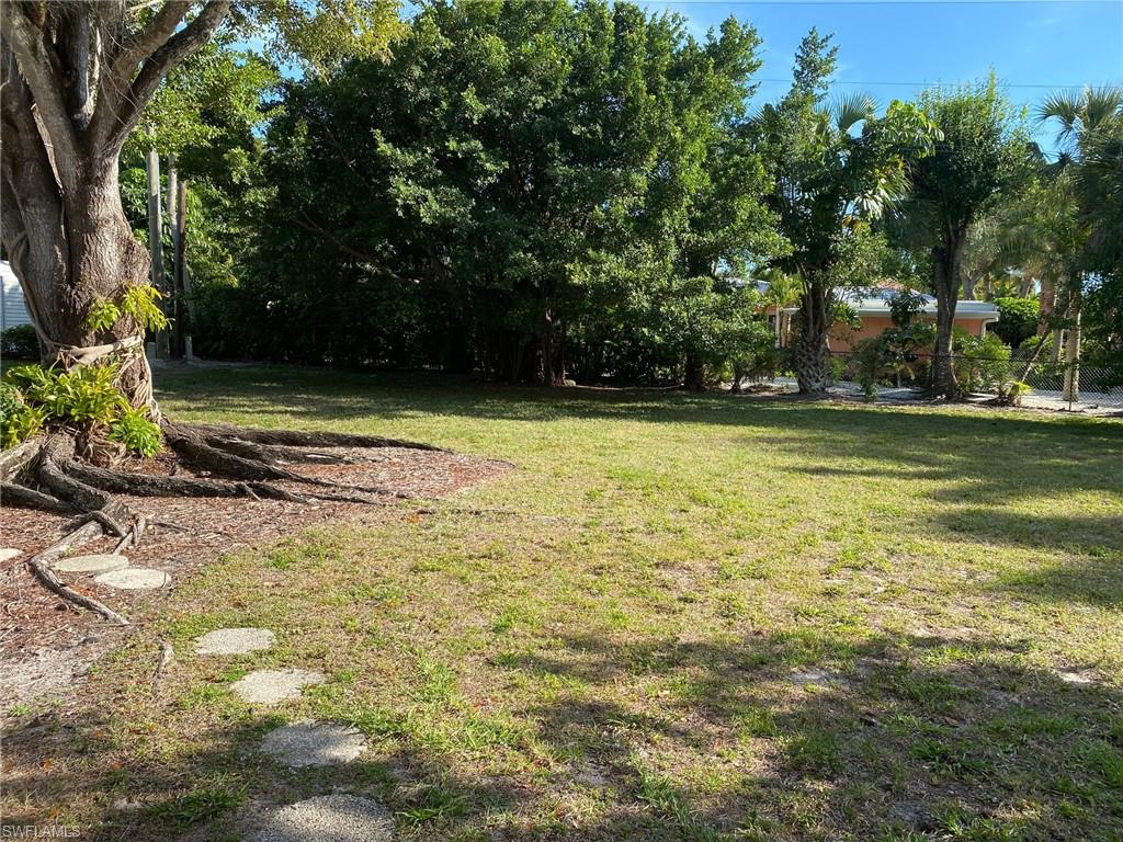 620 Orchid Drive Naples, FL 34102 - Photo 4 of 16 a view of a yard with a trees