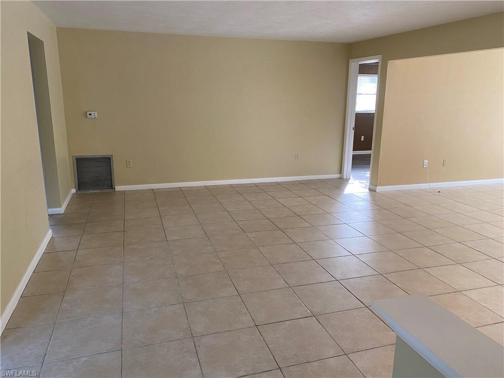 620 Orchid Drive Naples, FL 34102 - Photo 6 of 16 wooden floor in a empty room