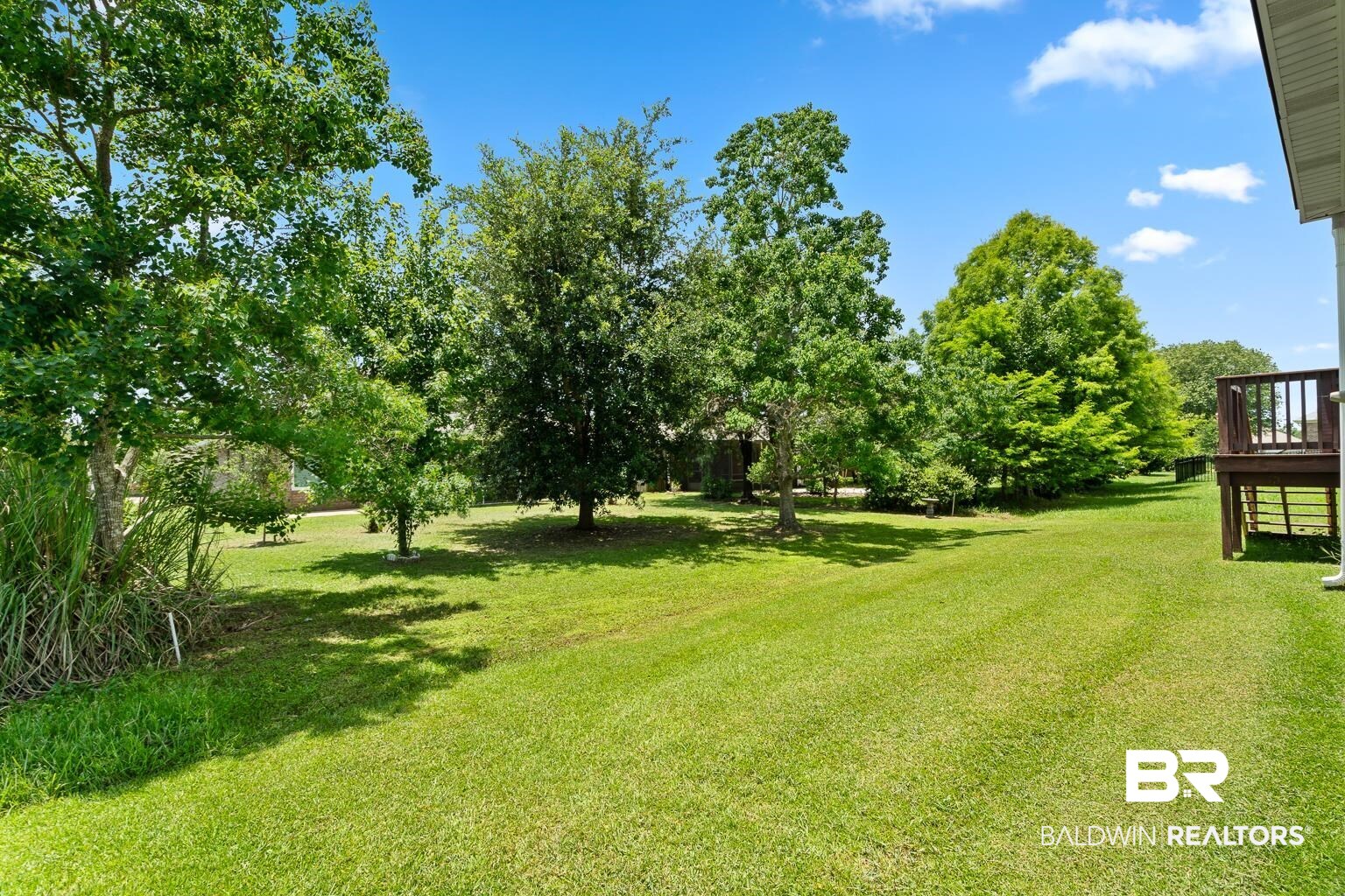 22764 Respite Lane Foley, AL 36535 - Photo 36 of 46 View of grassy yard with a deck