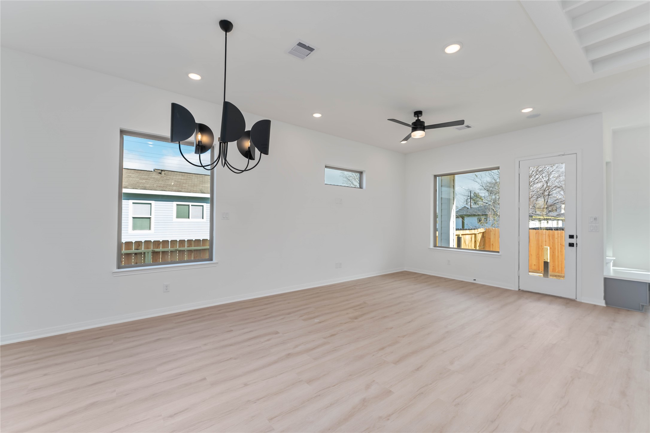 3508 Delhi Street Houston, TX 77022 - Photo 12 of 38 a view of an empty room with a window and wooden floor