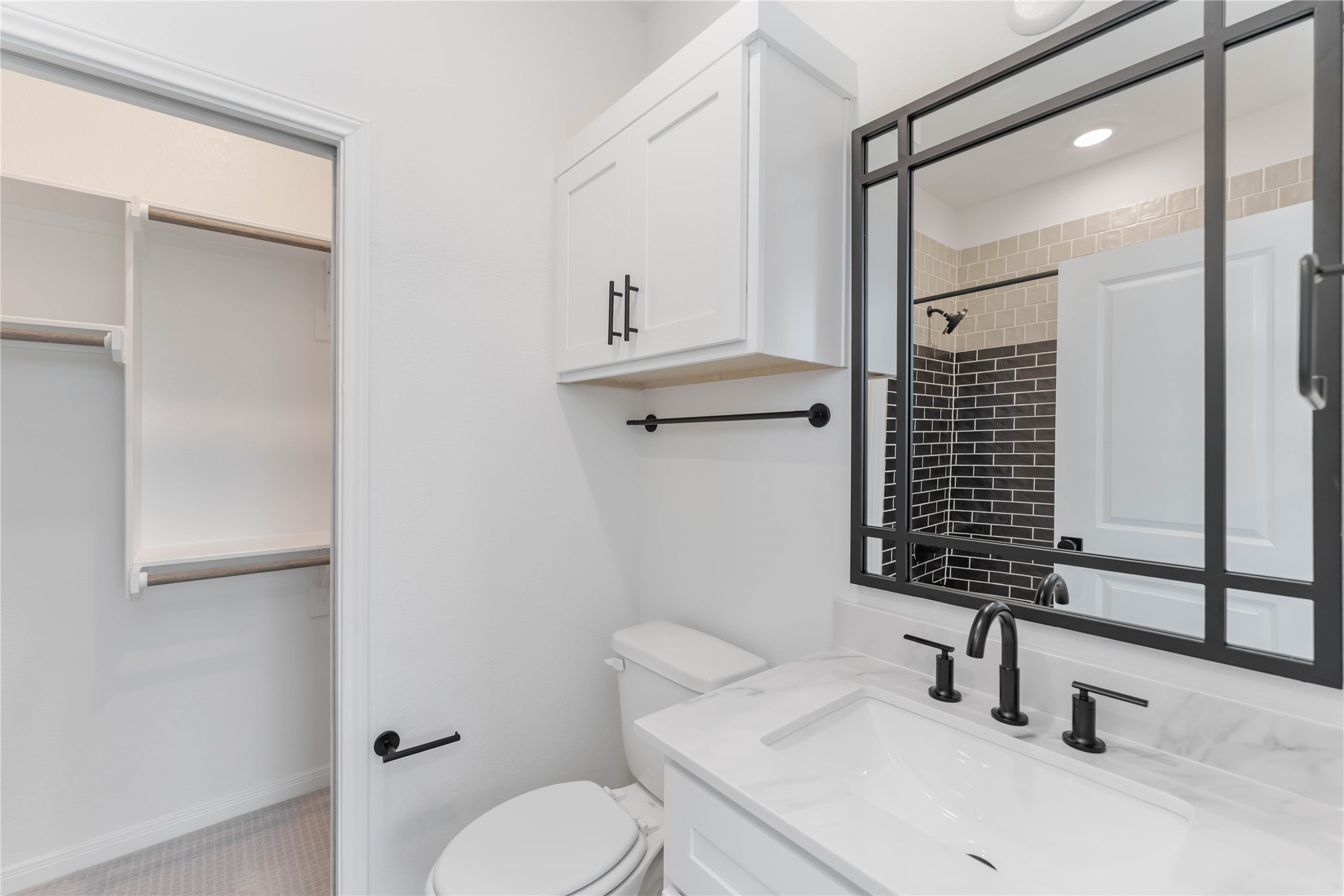 3508 Delhi Street Houston, TX 77022 - Photo 22 of 38 a bathroom with a sink toilet a mirror and shower