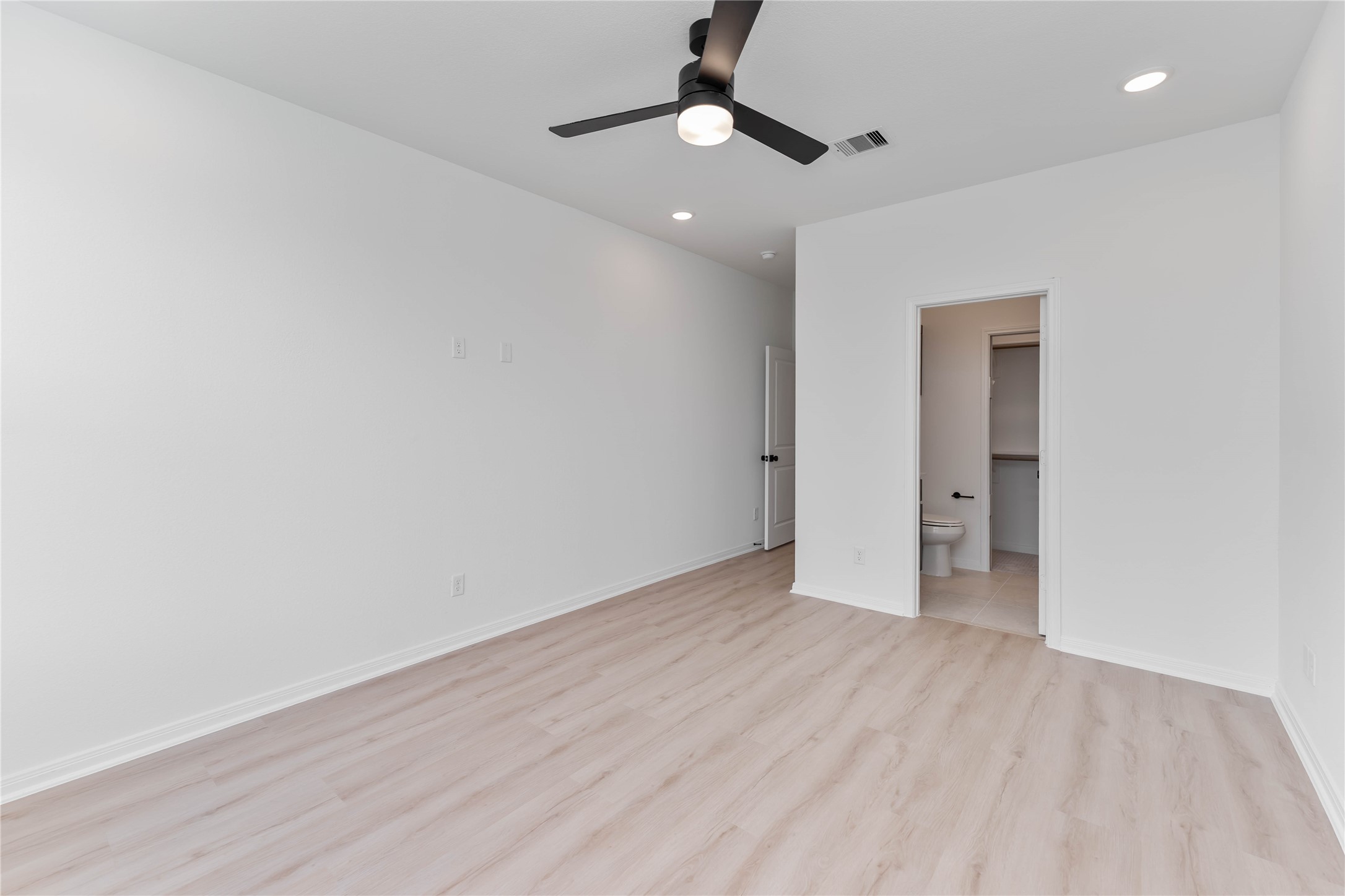3508 Delhi Street Houston, TX 77022 - Photo 25 of 38 an empty room with wooden floor and a ceiling fan