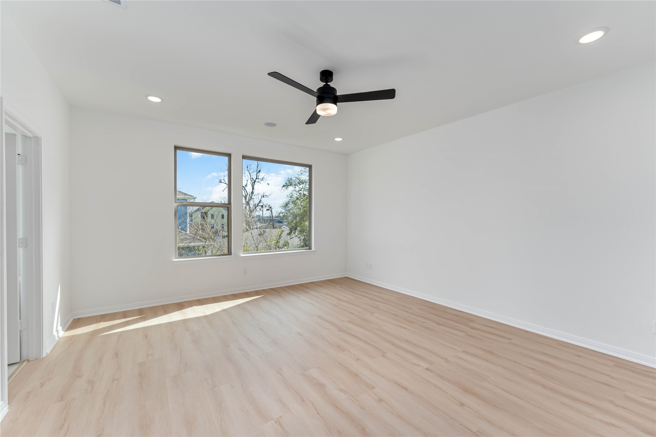 3508 Delhi Street Houston, TX 77022 - Photo 29 of 38 an empty room with wooden floor ceiling fan and windows
