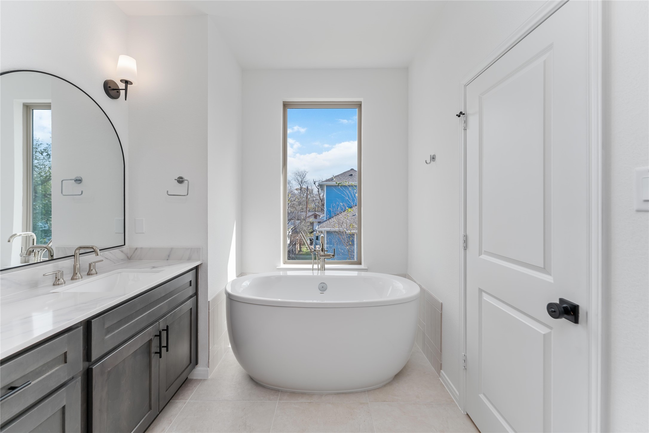 3508 Delhi Street Houston, TX 77022 - Photo 33 of 38 a bathroom with a white bath tub a sink and mirror