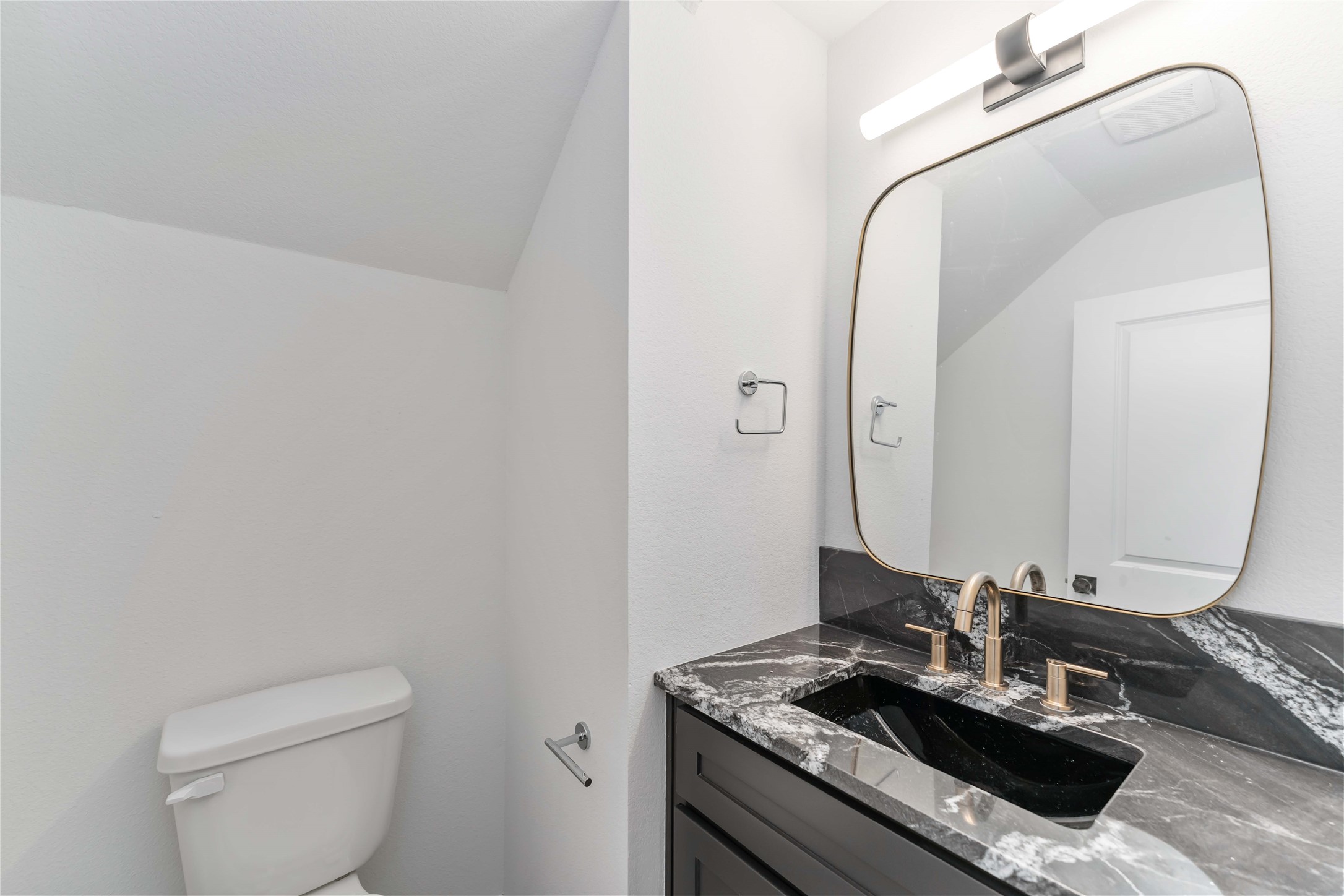 3508 Delhi Street Houston, TX 77022 - Photo 36 of 38 a bathroom with a granite countertop sink a toilet and a mirror