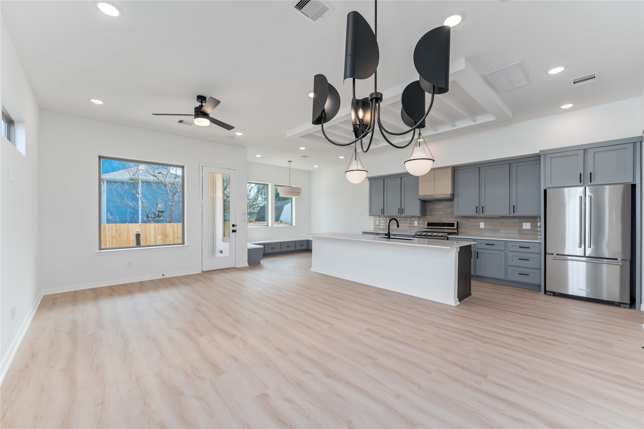 3508 Delhi Street Houston, TX 77022 - Photo 6 of 38 a kitchen with stainless steel appliances granite countertop a white stove top oven and chandelier