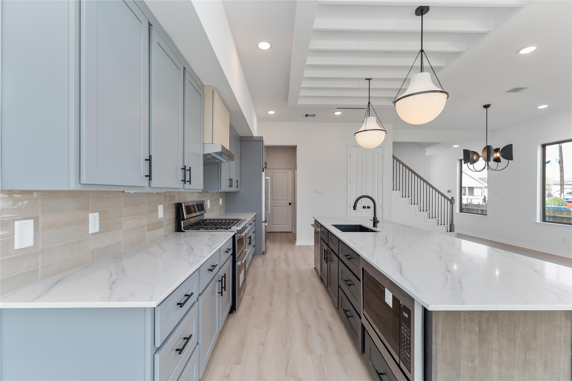 3508 Delhi Street Houston, TX 77022 - Photo 8 of 38 a large kitchen with stainless steel appliances granite countertop a sink a stove and a wooden floors